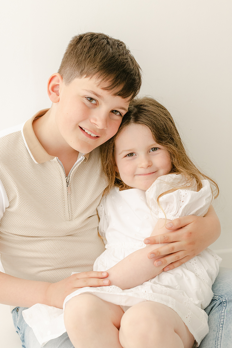 young brother and sister smiling at camera