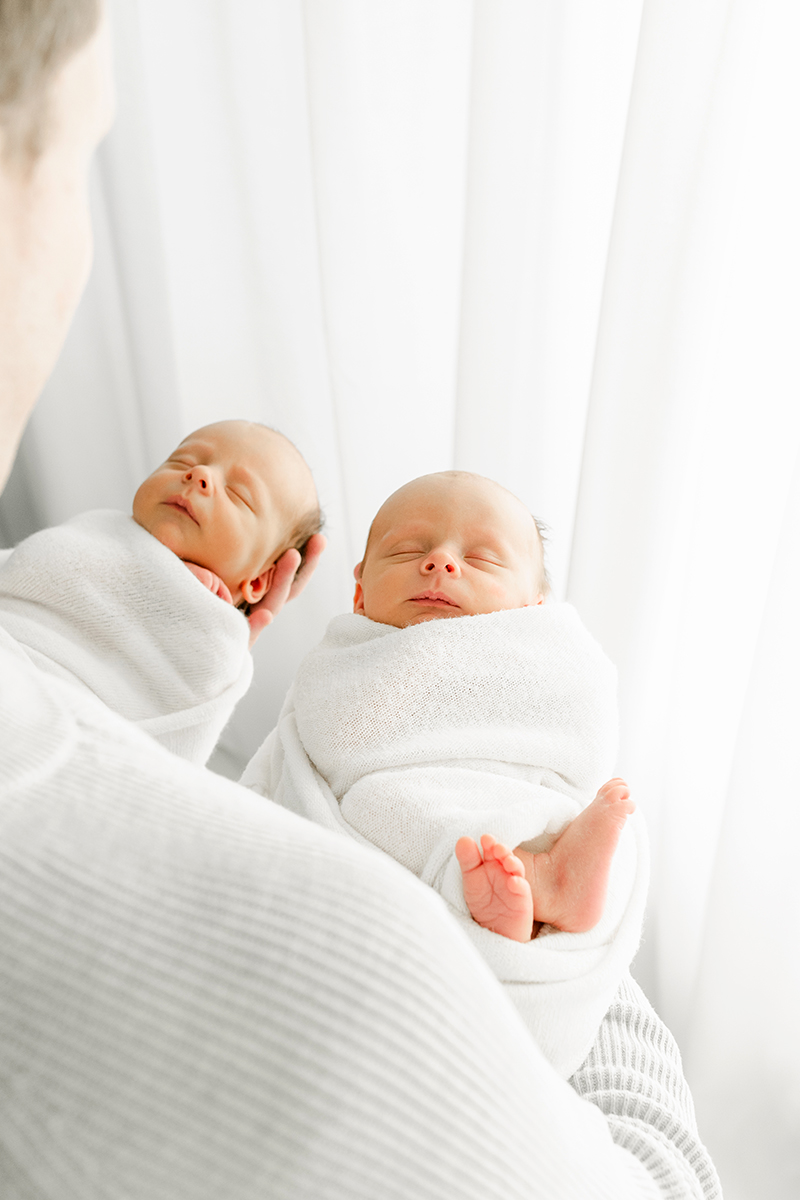 dad holding twins in arms