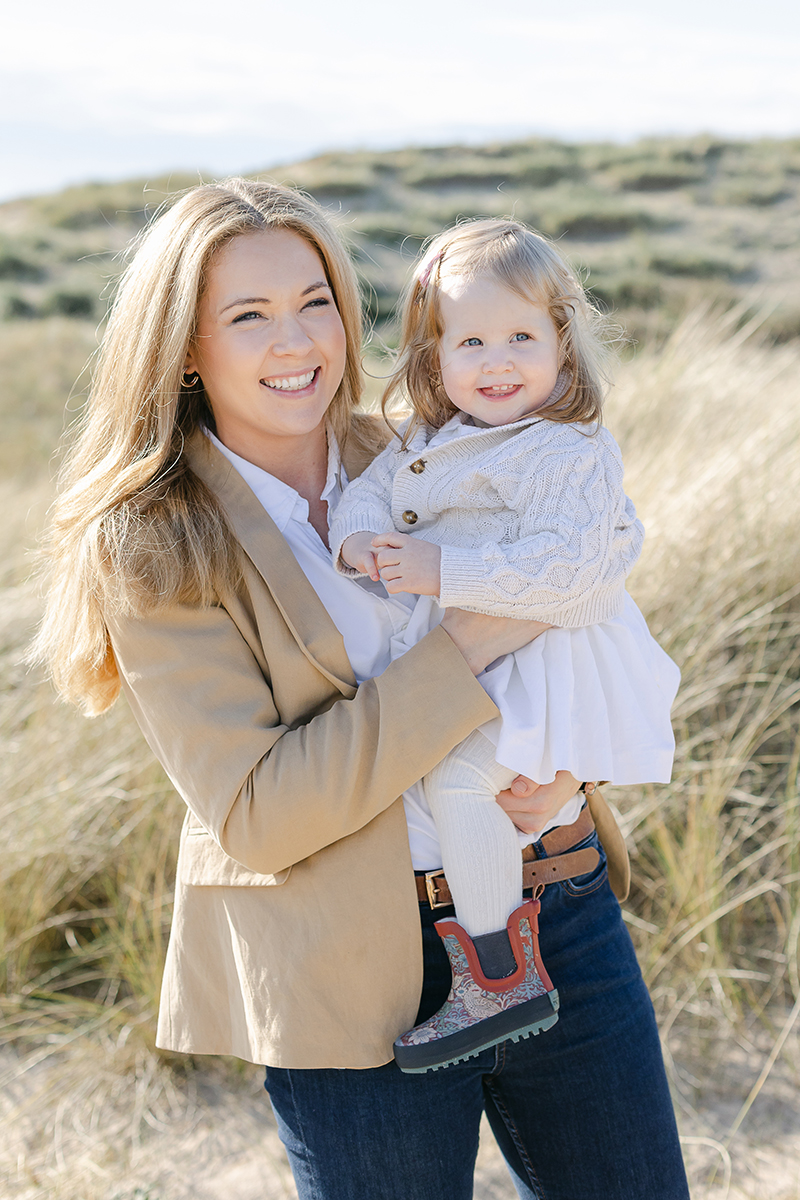 mum and daughter in dunes smiling at camera