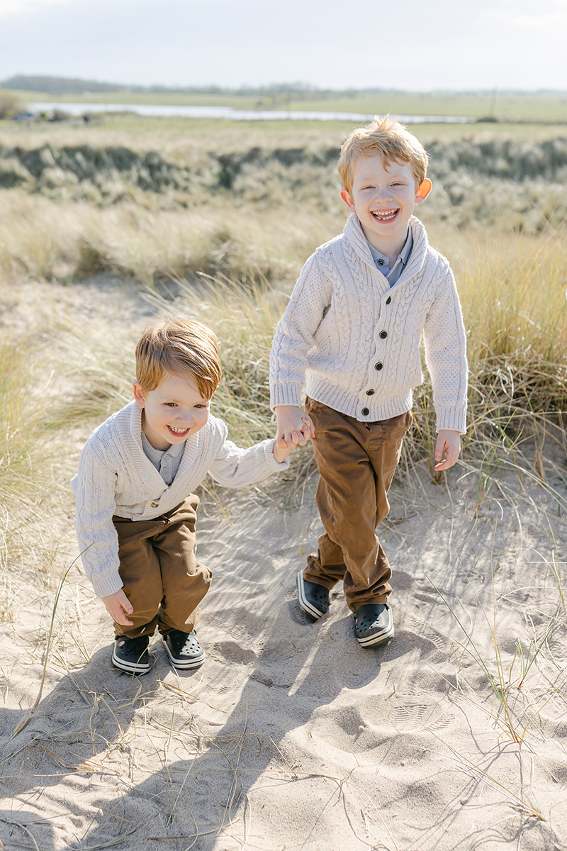 brothers laughing in dunes