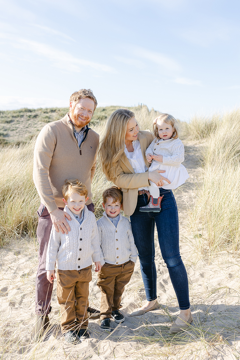 parents with 3 children in dunes grass