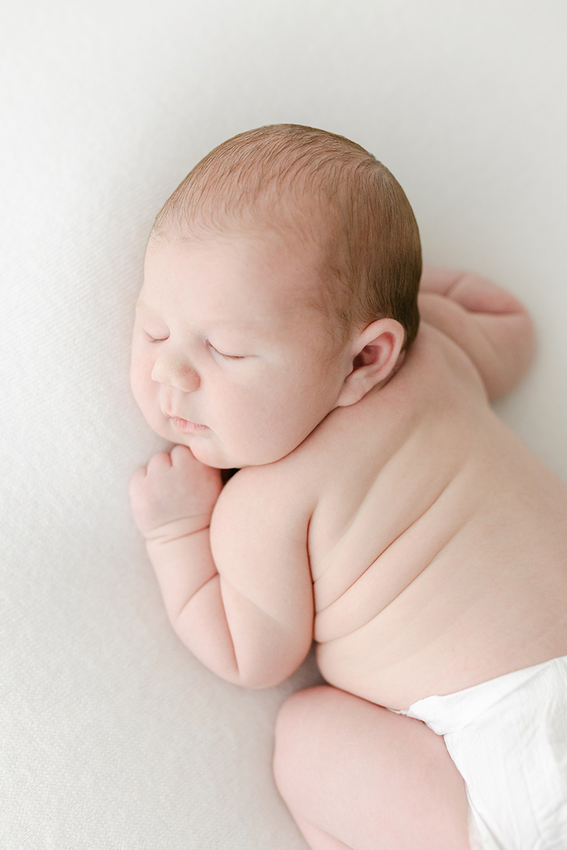 newborn asleep on front for newborn photoshoot