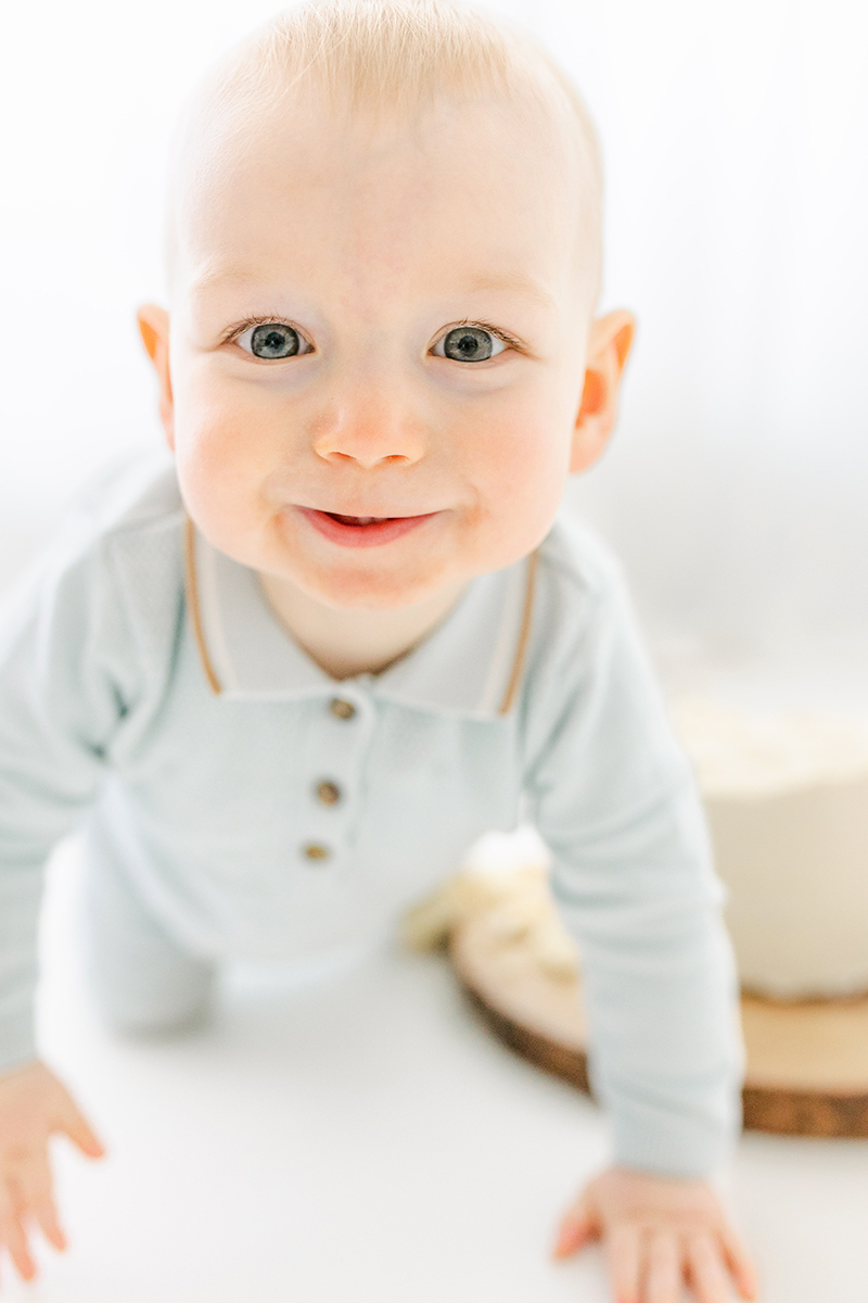 little baby crawling and smiling into camera