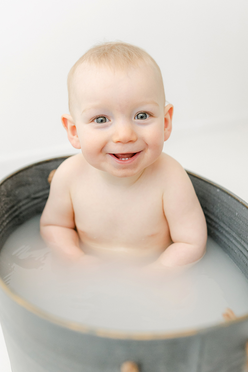 little boy in tin bath smiling