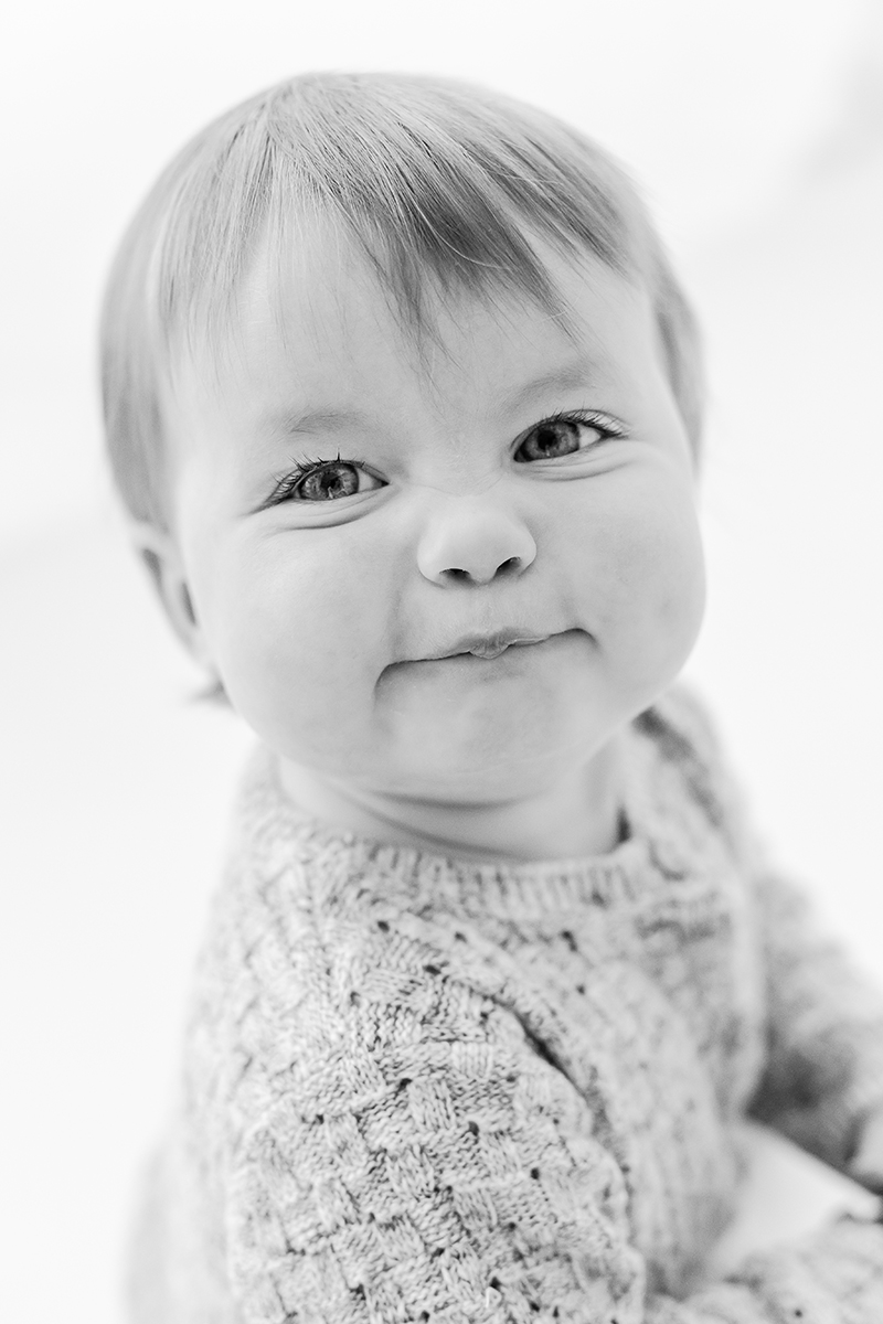 toddler pulling face at camera black and white