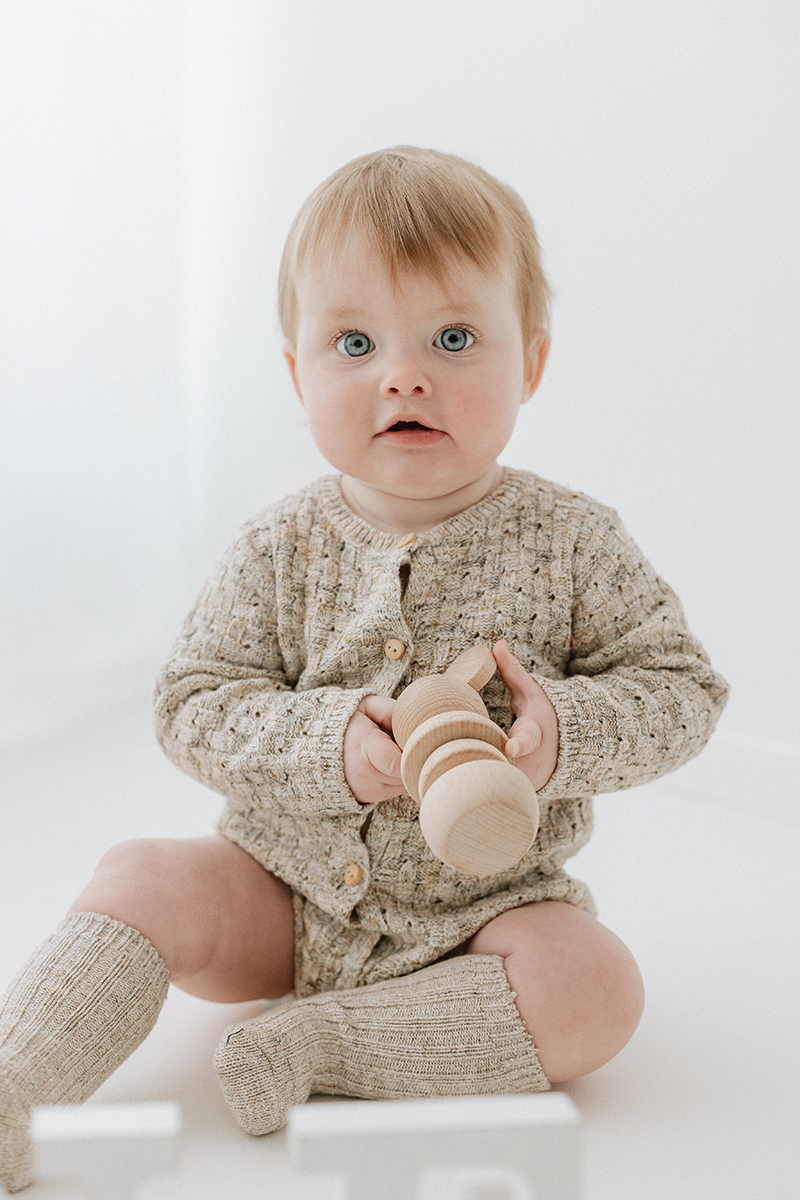 little girl playing with wooden mouse