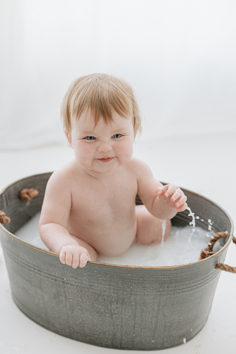 toddler splashing in tin bath